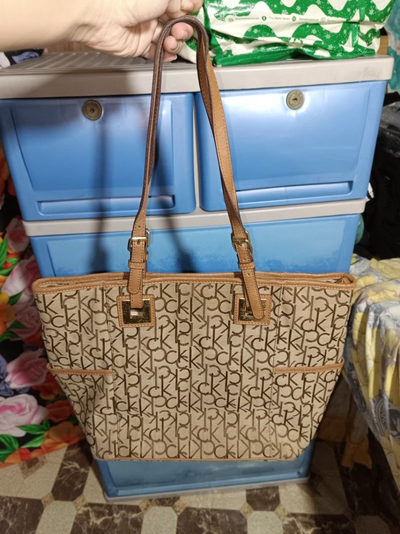 Calvin Klein Monogram Canvas Tote Bag (Category: Tote Bags) located in Manila. Submitted by caaths_collection (Listing ID 1440897866, Image 2). Description: - Classic Calvin Klein tote bag - Signature CK monogram pattern - Tan leather straps and trim - Spacious interior for essentials - Ideal for everyday use or travel - Calvin Klein Monogram Canvas Tote Bag - preloved.