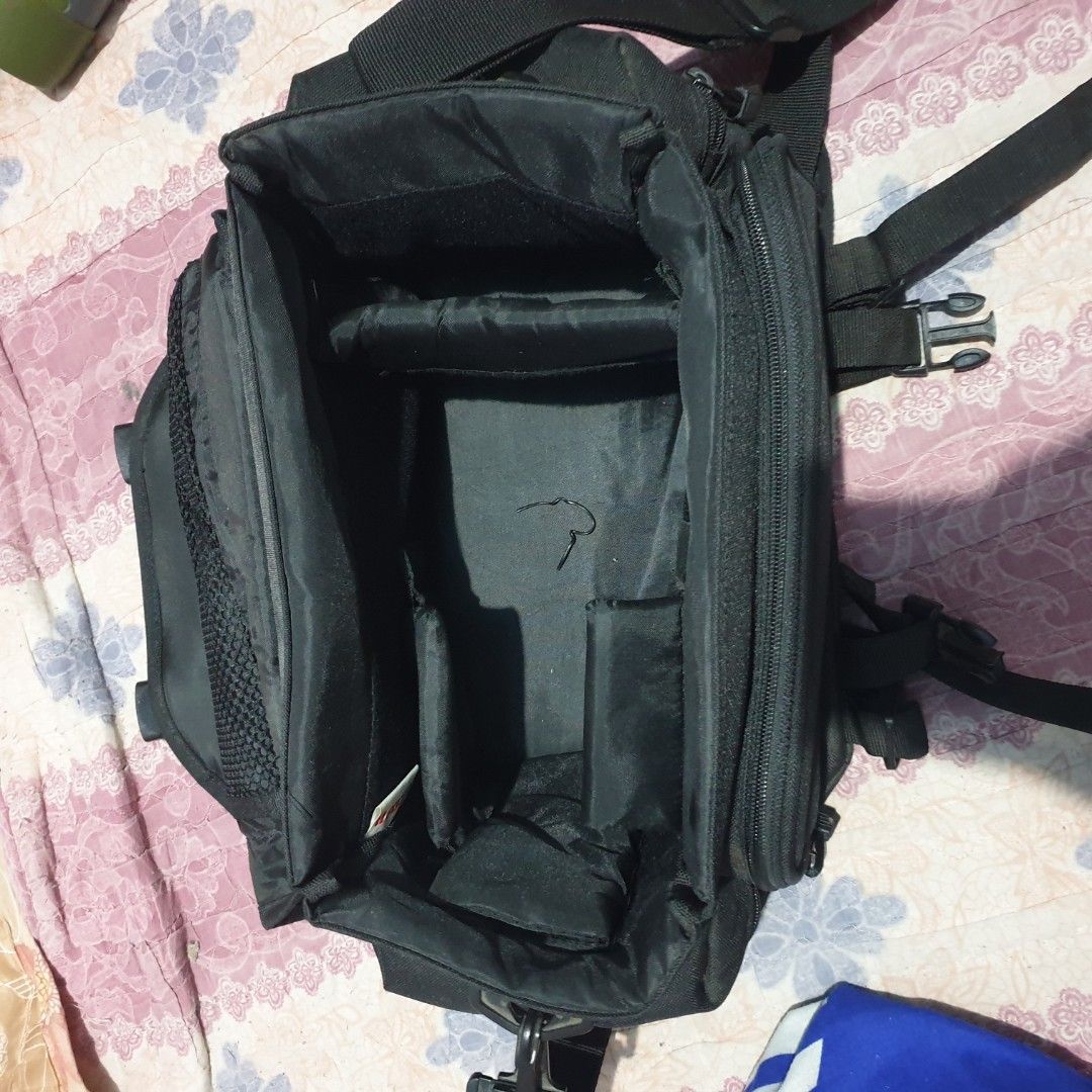 Canon Black Camera Bag with Adjustable Straps (Category: Camera Bags & Carriers) located in Barotac Nuevo. Submitted by ehsherjohn27 (Listing ID 1440774737, Image 3). Description: - Black Canon camera bag - Multiple interior compartments for organization - Adjustable straps for comfortable carrying - Zippers in good working order - Ideal for photographers on the go.