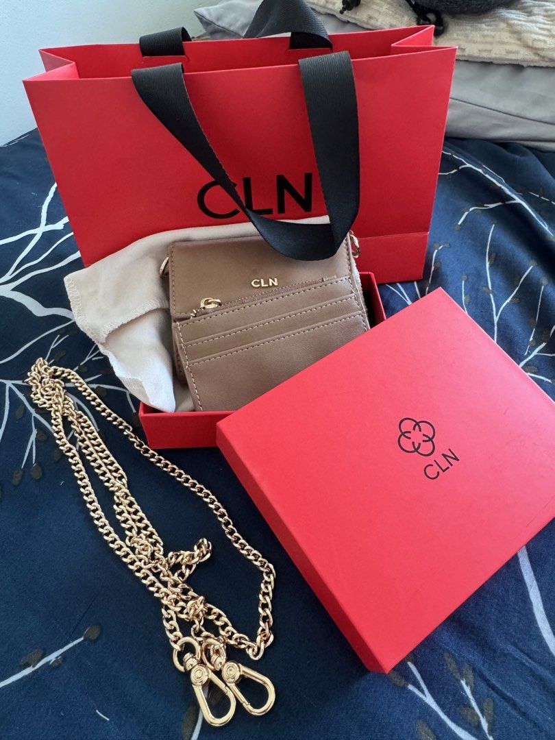CLN Brown Wallet with Chain and Card Holder (Category: Wallets & Card holders) located in Makati City. Submitted by danittt (Listing ID 1440808025, Image 3). Description: Brown CLN wallet. Comes with a gold chain strap and a matching card holder. Has multiple card slots inside and a key holder. Includes the original CLN dust bag, red box, and shopping bag. Great for carrying essentials. RFS: Decluttering .