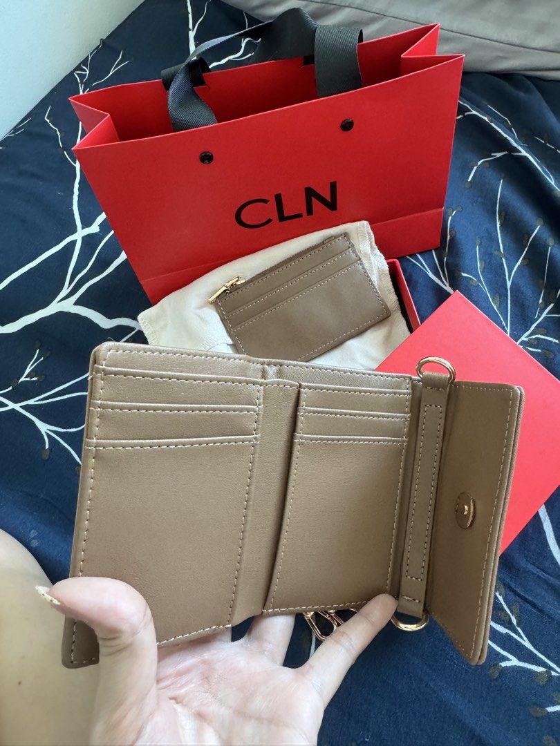 CLN Brown Wallet with Chain and Card Holder (Category: Wallets & Card holders) located in Makati City. Submitted by danittt (Listing ID 1440808025, Image 2). Description: Brown CLN wallet. Comes with a gold chain strap and a matching card holder. Has multiple card slots inside and a key holder. Includes the original CLN dust bag, red box, and shopping bag. Great for carrying essentials. RFS: Decluttering .
