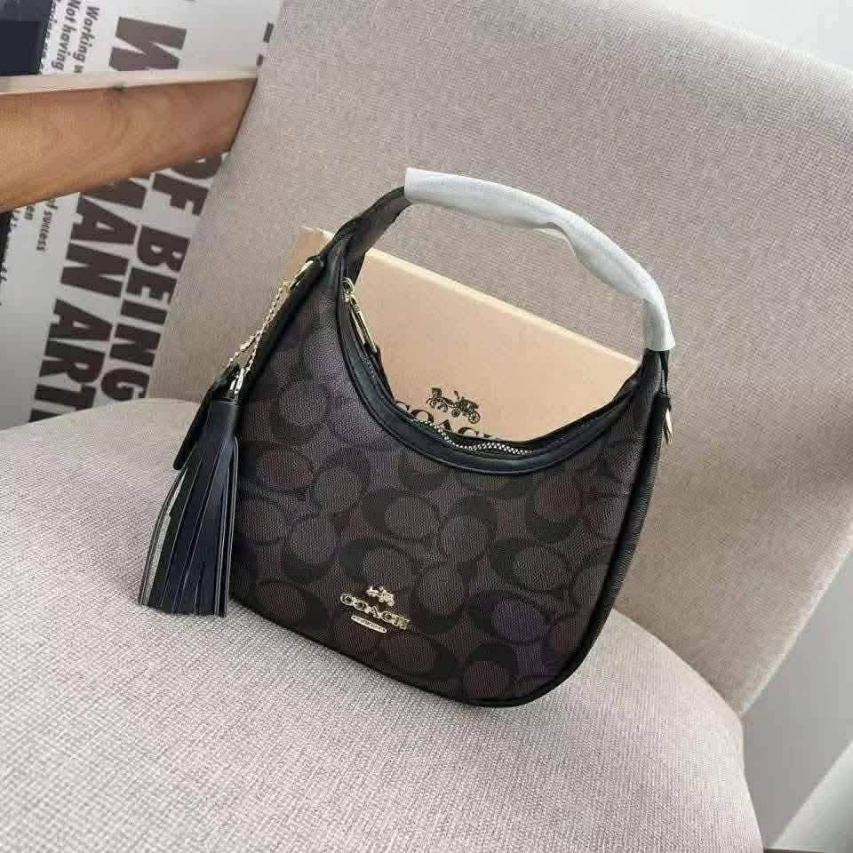 Coach Signature Hobo Shoulder Bag (Category: Luxury Bags & Wallets) located in Manila. Submitted by coachluxurybag (Listing ID 1440831072, Image 2). Description: - Coach hobo bag - Signature print available in brown or pink - Plain black leather option also available - Features a stylish tassel detail - Ideal for everyday use - Fits all your essentials - Comes with a dust bag.