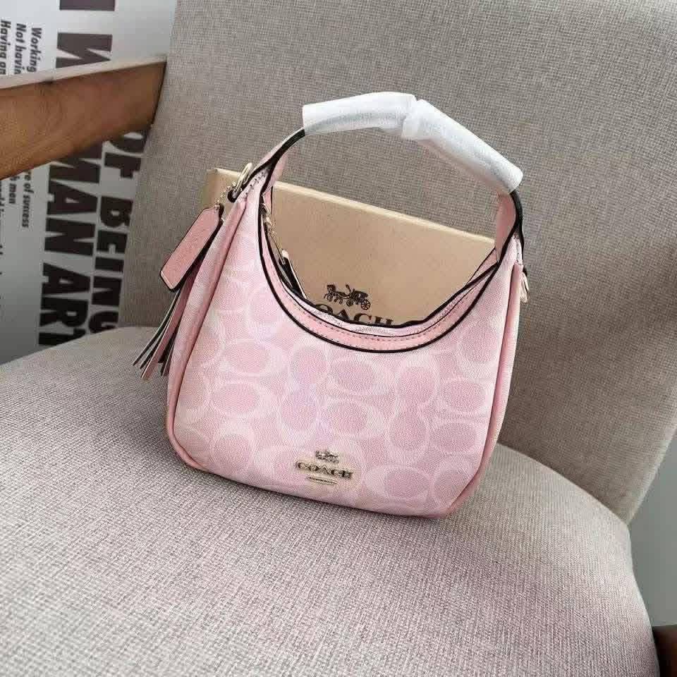 Coach Signature Hobo Shoulder Bag (Category: Luxury Bags & Wallets) located in Manila. Submitted by coachluxurybag (Listing ID 1440831072, Image 1). Description: - Coach hobo bag - Signature print available in brown or pink - Plain black leather option also available - Features a stylish tassel detail - Ideal for everyday use - Fits all your essentials - Comes with a dust bag.