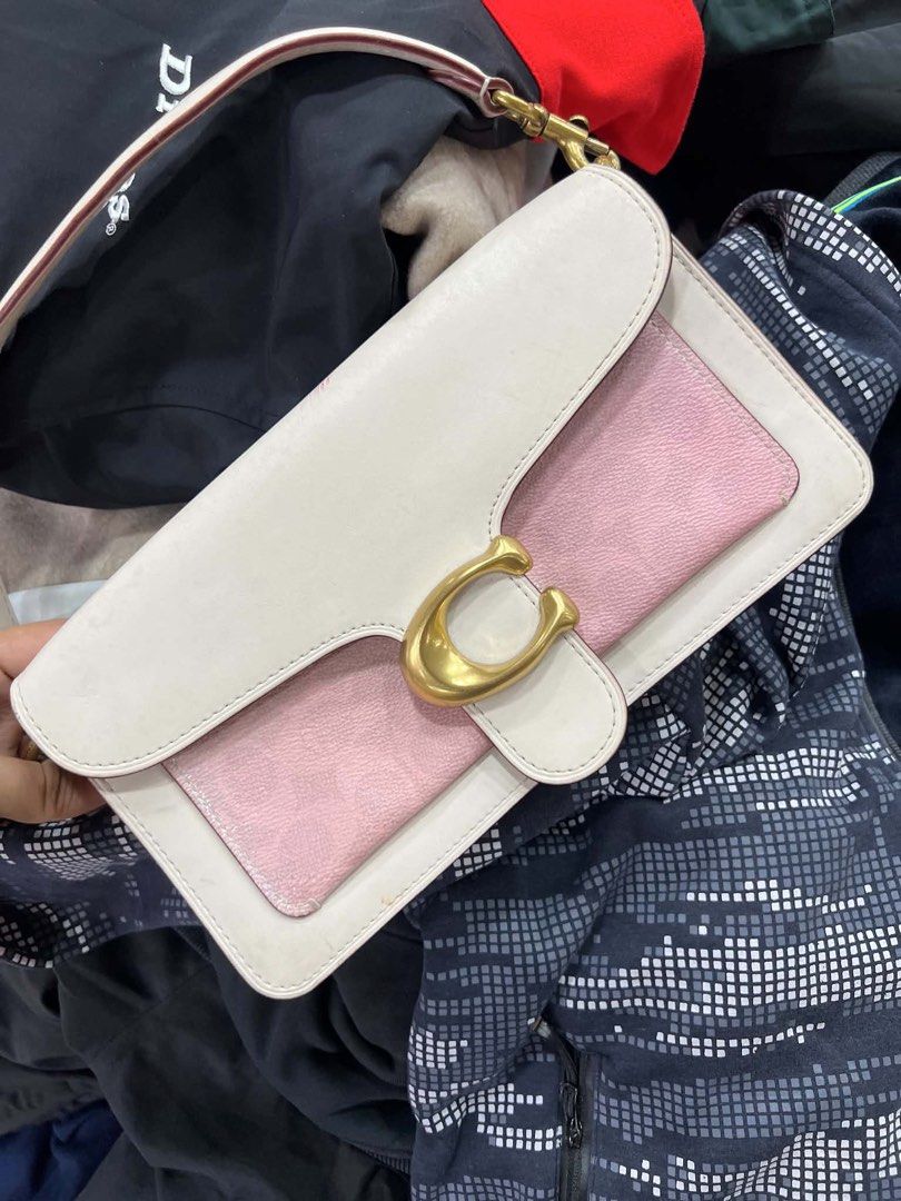 Coach Tabby Shoulder Bag 26 White Pink (Category: Luxury Bags & Wallets) located in Bacolod City. Submitted by novymaesel14868 (Listing ID 1440786923, Image 1). Description: - Authentic Coach Tabby shoulder bag - Chic white and pink colorway - Iconic Coach 'C' hardware - Multiple interior compartments for organization - Interior zip pocket for secure storage - Adjustable leather strap with gold-tone hardware - Comes with original Coach dust bag -