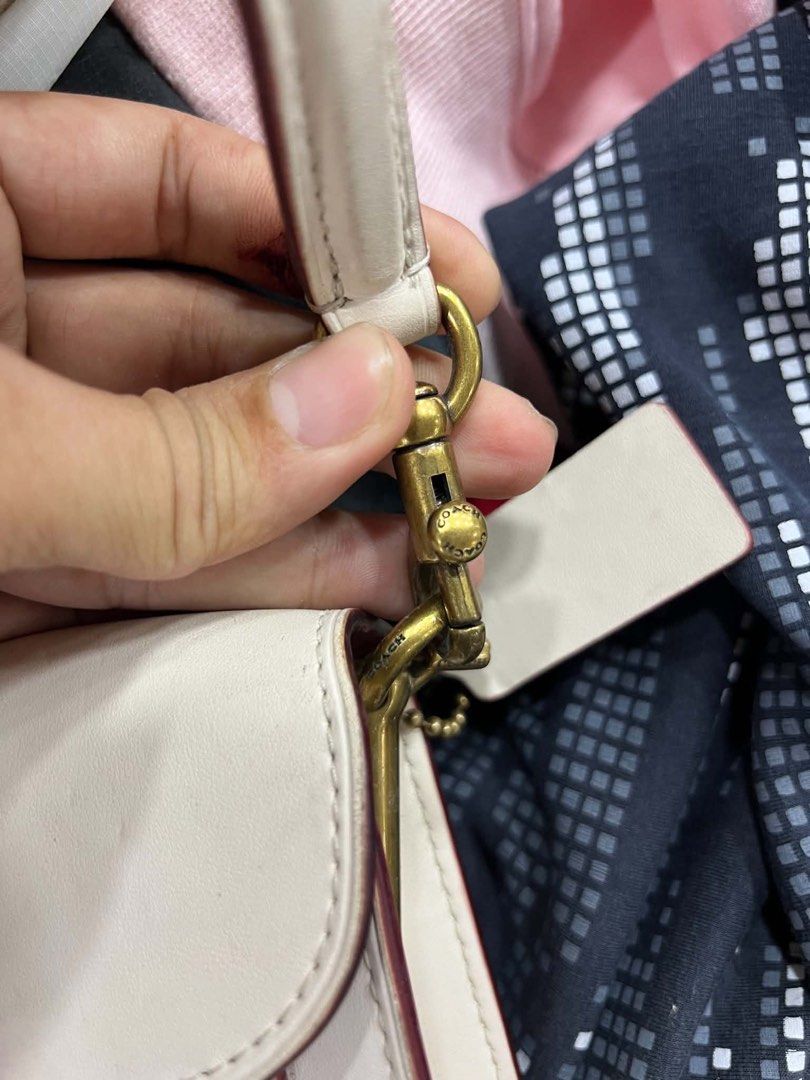 Coach Tabby Shoulder Bag 26 White Pink (Category: Luxury Bags & Wallets) located in Bacolod City. Submitted by novymaesel14868 (Listing ID 1440786923, Image 3). Description: - Authentic Coach Tabby shoulder bag - Chic white and pink colorway - Iconic Coach 'C' hardware - Multiple interior compartments for organization - Interior zip pocket for secure storage - Adjustable leather strap with gold-tone hardware - Comes with original Coach dust bag -