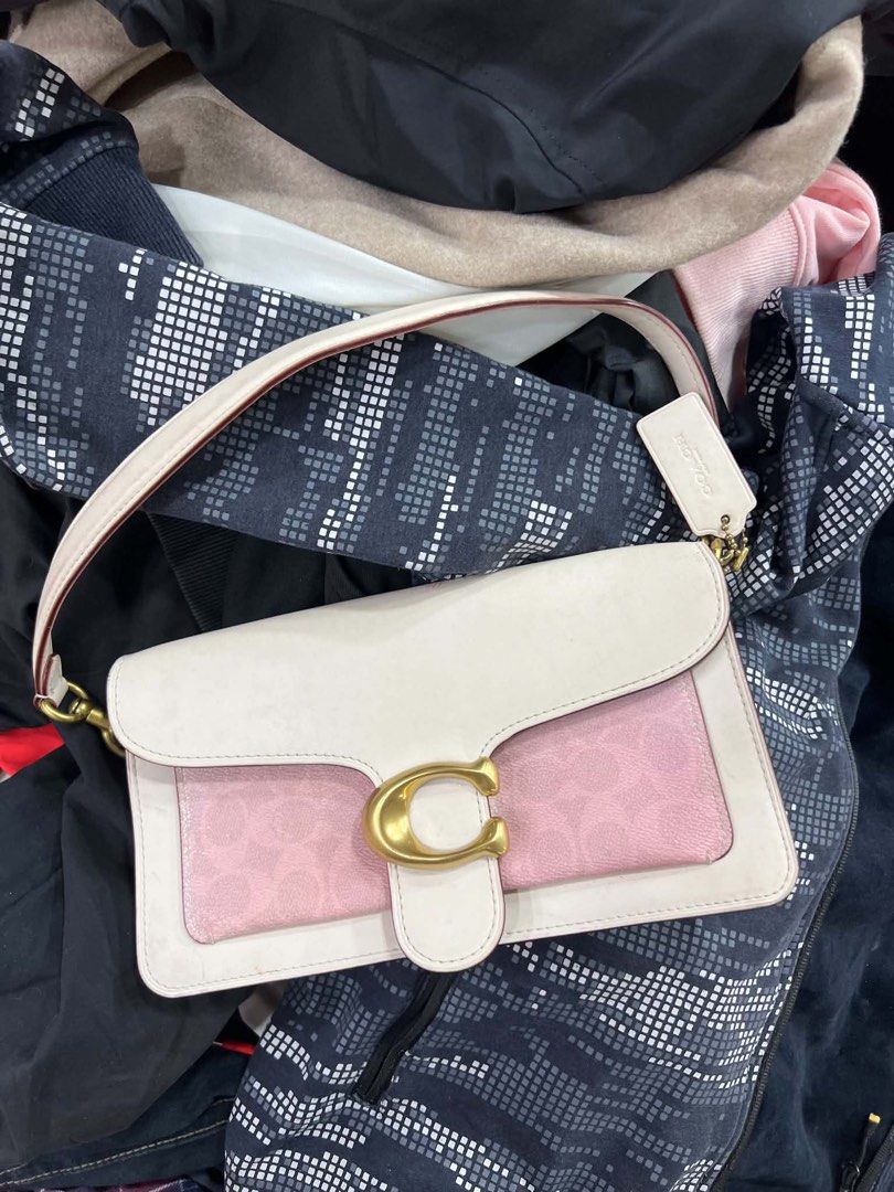 Coach Tabby Shoulder Bag 26 White Pink (Category: Luxury Bags & Wallets) located in Bacolod City. Submitted by novymaesel14868 (Listing ID 1440786923, Image 2). Description: - Authentic Coach Tabby shoulder bag - Chic white and pink colorway - Iconic Coach 'C' hardware - Multiple interior compartments for organization - Interior zip pocket for secure storage - Adjustable leather strap with gold-tone hardware - Comes with original Coach dust bag -