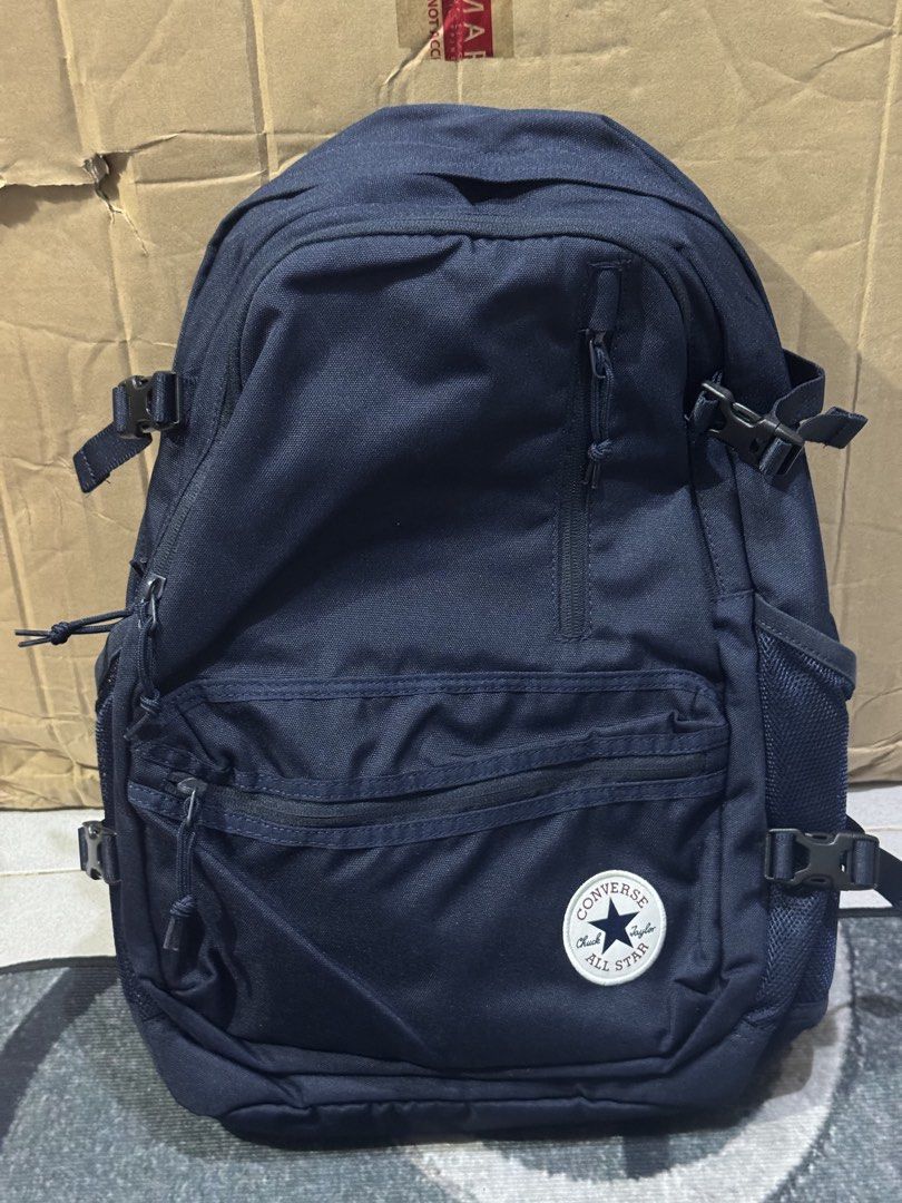 Converse All Star Navy Blue Backpack (Category: Backpacks) located in Rodriguez. Submitted by leo_mjjmpj (Listing ID 1440774294, Image 1). Description: - Navy blue Converse backpack - Multiple zip pockets on the front - Side mesh pockets for water bottles or essentials - Adjustable straps for a comfortable fit - Plenty of interior space - Ideal for school, work, or everyday adventures.