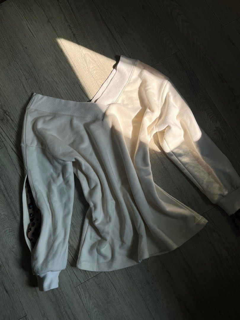 Cream Sweatshirt with Leopard Print Detail (Category: Longsleeves) located in Manila. Submitted by declutbyal (Listing ID 1440882714, Image 1). Description: - Cream colored sweatshirt - Long sleeves with ribbed cuffs - Subtle leopard print detail on side slit - Soft material for ultimate comfort - Relaxed fit, ideal for casual wear.