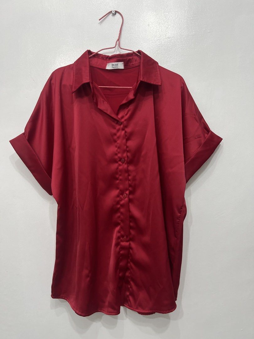 DUDE Red Satin Oversized Short Sleeve Button Up Shirt (Category: Shirts) located in Pasig City. Submitted by munchinitajanella (Listing ID 1440783045, Image 1). Description: - DUDE brand red satin shirt - Oversized fit - Short sleeves with cuffed detail - Button-up front - Perfect for casual wear or dressing up for a night out.