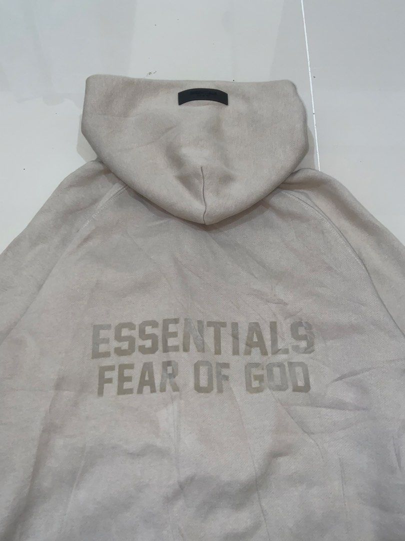 Fear of God Essentials Beige Zip-Up Hoodie (Category: Hoodies) located in Lapu Lapu. Submitted by trip-thrift (Listing ID 1440807550, Image 2). Description: - Beige zip-up hoodie from Fear of God Essentials - Features the signature Essentials logo prominently on the back - Comfortable and stylish design, ideal for layering - Versatile piece for casual outfits.