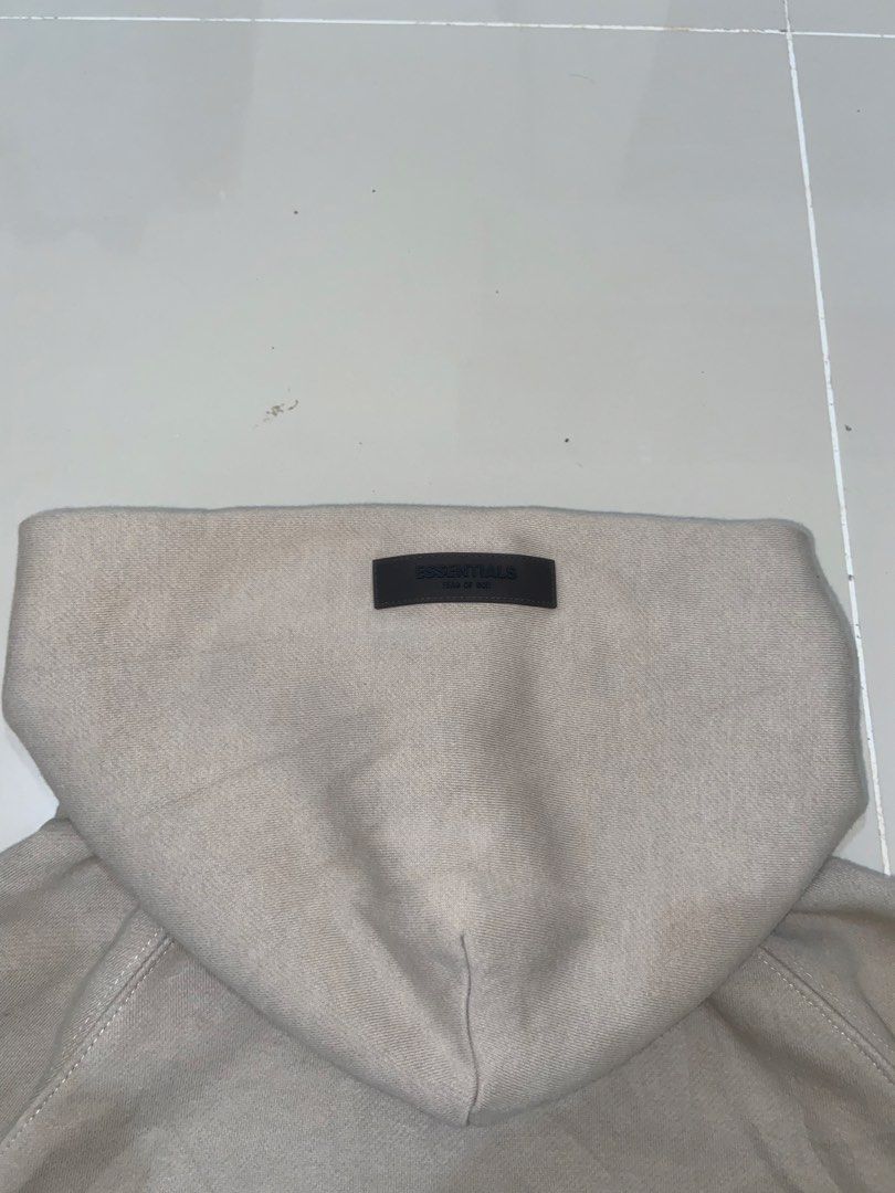 Fear of God Essentials Beige Zip-Up Hoodie (Category: Hoodies) located in Lapu Lapu. Submitted by trip-thrift (Listing ID 1440807550, Image 3). Description: - Beige zip-up hoodie from Fear of God Essentials - Features the signature Essentials logo prominently on the back - Comfortable and stylish design, ideal for layering - Versatile piece for casual outfits.