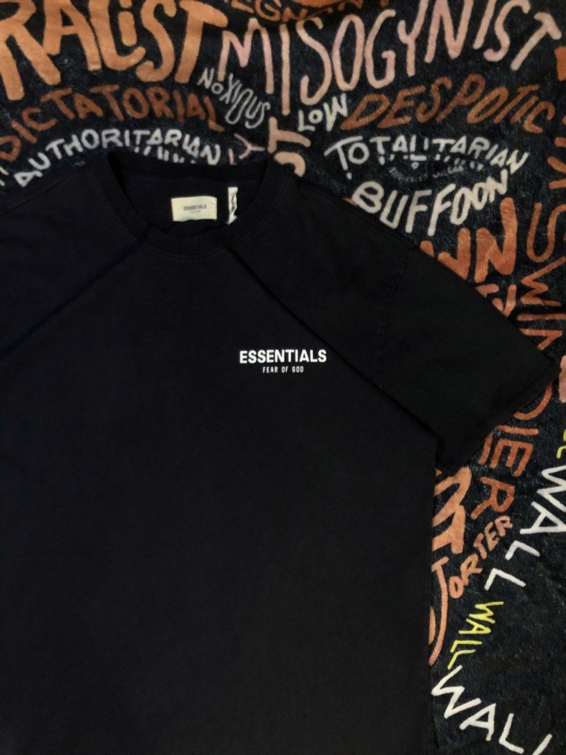 Fear of God Essentials Black T-Shirt with Beach Graphic (Category: Tshirts & Polo Shirts ) located in Manila. Submitted by mariellathrift (Listing ID 1440852077, Image 2). Description: - Brand: Fear of God Essentials - Color: Black - Size: Medium (M) - Front Design: 'ESSENTIALS' logo - Back Design: Small beach scene graphic - Material: 100% Cotton.