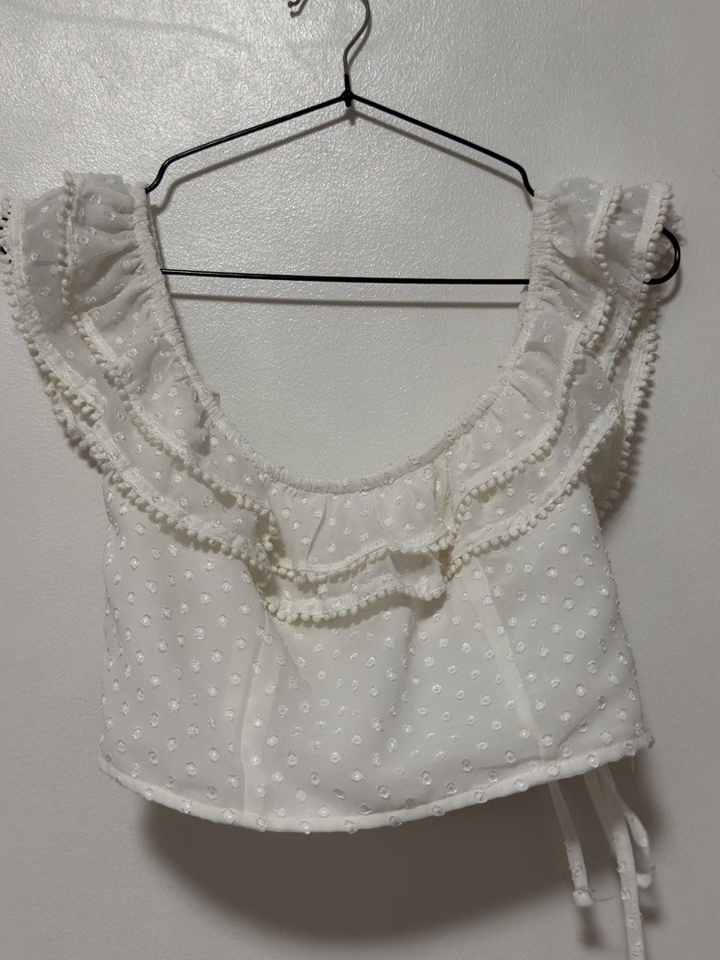 Forever 21 White Off-Shoulder Ruffle Crop Top (Category: Others Tops) located in Cabanatuan. Submitted by midaxadim (Listing ID 1440876935, Image 1). Description: - White off-shoulder crop top - Brand: Forever 21 - Features: Swiss dot pattern, ruffled trim, pom-pom details -Small on tag pero fits like XS po.