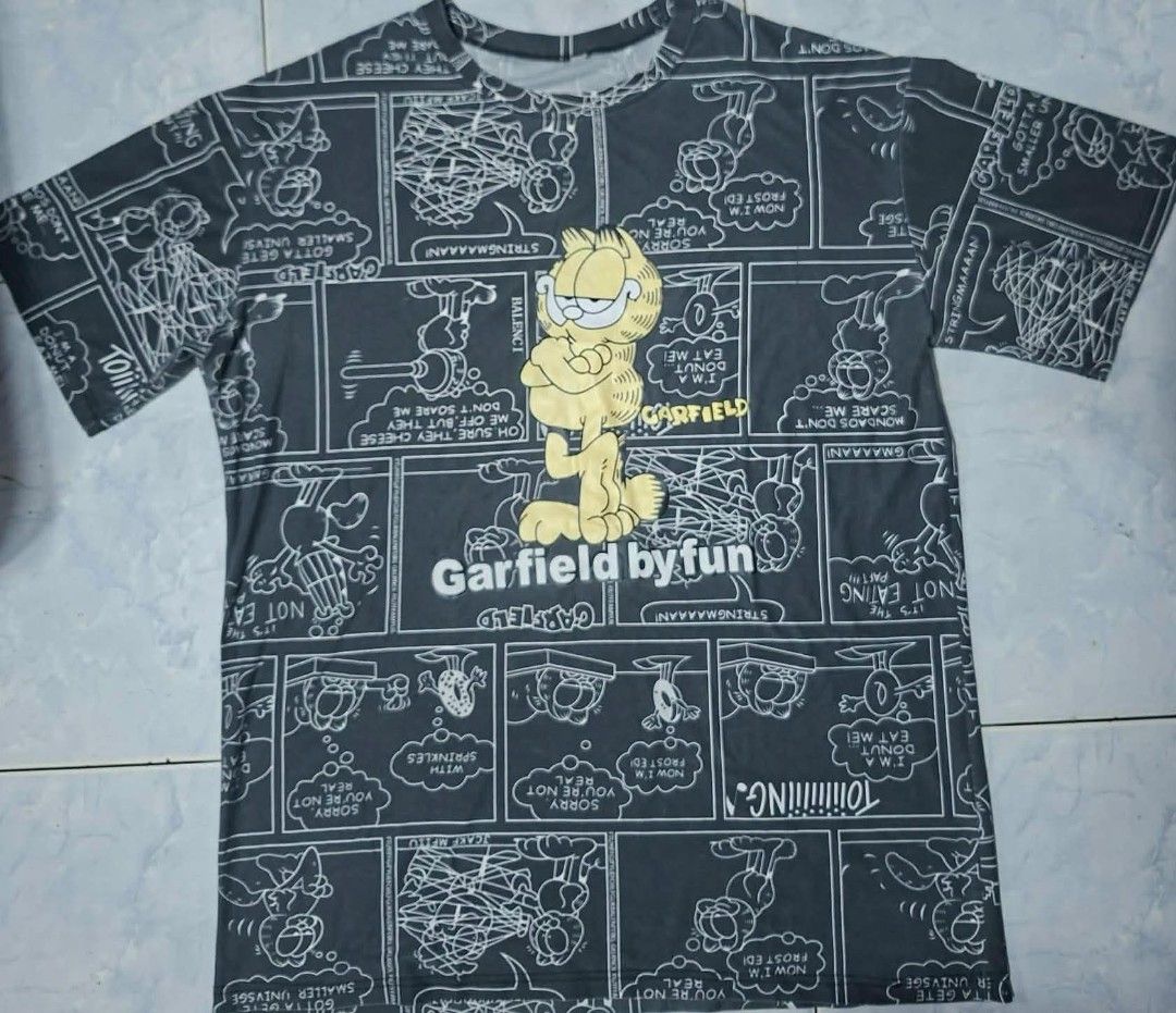 Garfield by Fun Graphic T-Shirt (Category: Tshirts & Polo Shirts ) located in Quezon City. Submitted by liaaaaaamm (Listing ID 1440941517, Image 1). Description: W: 24 L: 31.5 manipis fabric like polyester.