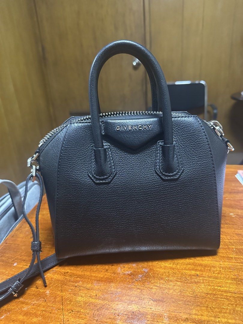 Givenchy Black Leather Antigona Mini Bag (Category: Luxury Bags & Wallets) located in San Juan City. Submitted by smartfindsph (Listing ID 1440909654, Image 1). Description: Black leather Givenchy Antigona bag. Mini size. Has top handles and a detachable shoulder strap. Silver hardware details. Zipper closure. Great for everyday use or nights out. Plenty of space inside for essentials. Only flaw: chipped rubber on one side, can be fixed with rubb