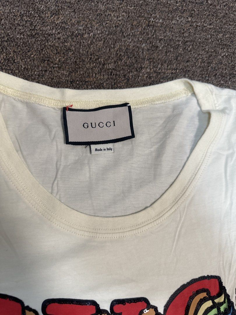 Gucci White Sequin Pig T-Shirt (Category: Shirts) located in Mandaluyong City. Submitted by krstls (Listing ID 1440819153, Image 2). Description: - Authentic White Gucci T-shirt - Features sparkling sequin details - Iconic Gucci logo and adorable pig graphic - Made in Italy - Perfect statement piece for any outfit.
