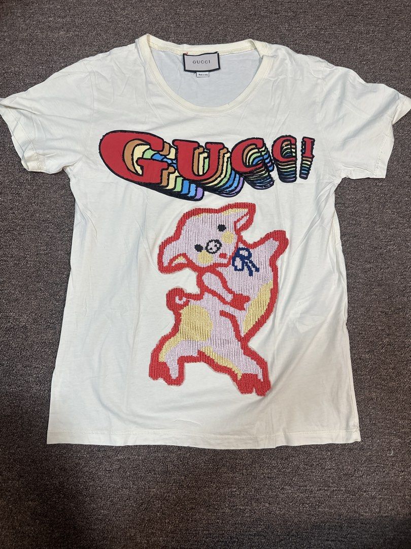Gucci White Sequin Pig T-Shirt (Category: Shirts) located in Mandaluyong City. Submitted by krstls (Listing ID 1440819153, Image 1). Description: - Authentic White Gucci T-shirt - Features sparkling sequin details - Iconic Gucci logo and adorable pig graphic - Made in Italy - Perfect statement piece for any outfit.