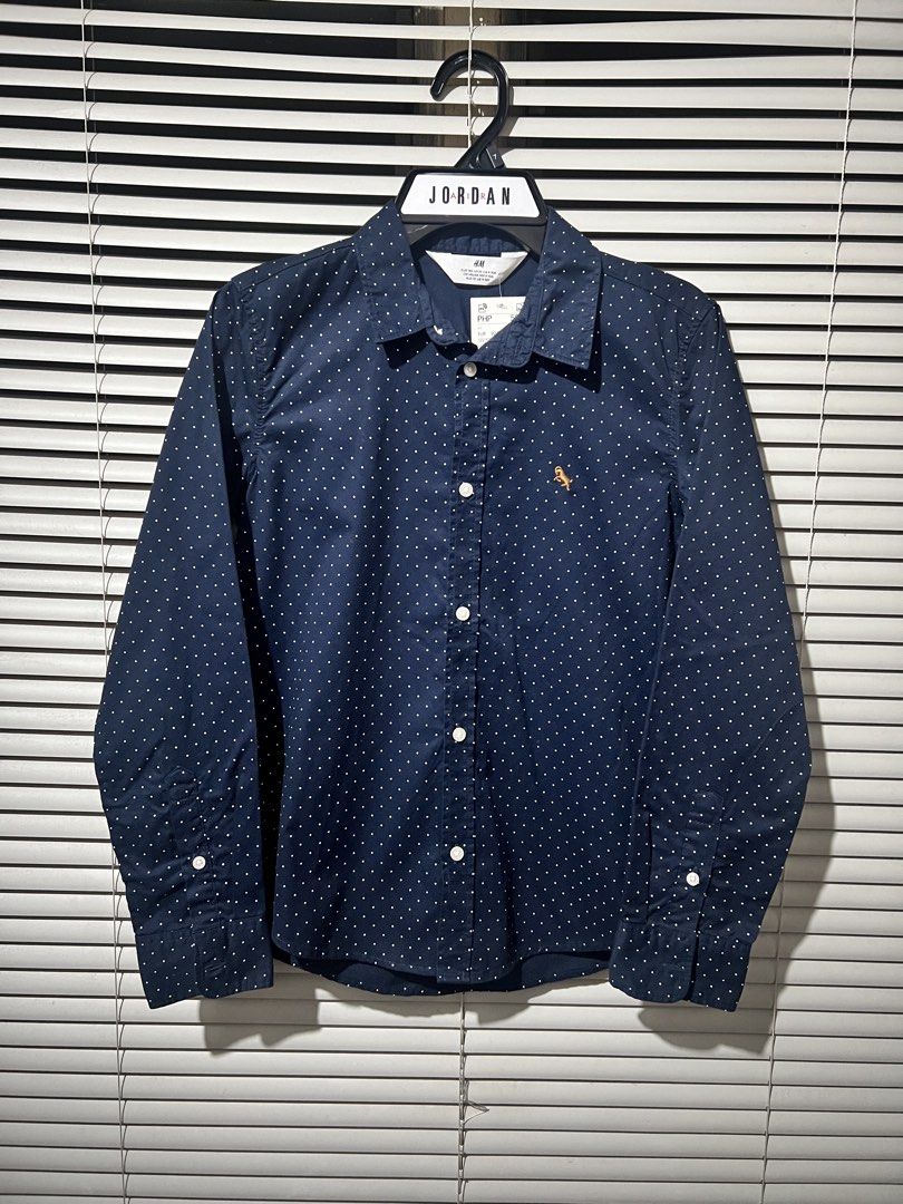H&M Navy Blue Polka Dot Shirt (Category: Babies & Kids Fashion) located in Quezon City. Submitted by Shopping_Nest (Listing ID 1440795510, Image 1). Description: - Brand: H&M - Color: Navy Blue - Style: Long-sleeved shirt - Pattern: All-over white polka dots - Closure: Button-up front with white buttons - Size: 9/10y on tag .