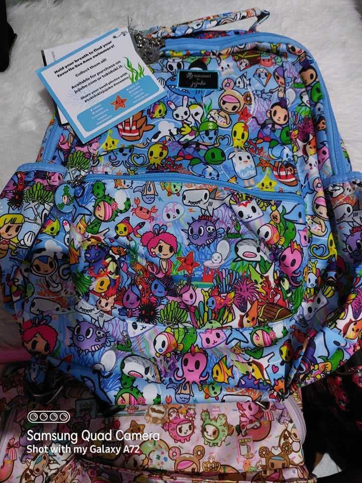 Ju-Ju-Be x tokidoki Sea Punk Backpack (Category: Backpacks) located in Dagupan City. Submitted by francesco11 (Listing ID 1440767790, Image 2). Description: - Adorable Ju-Ju-Be x tokidoki backpack - Features the vibrant Sea Punk print with fun characters and sea creatures - Light blue trim and straps for a stylish look - Convenient side pockets for easy access - Front zippered pocket for secure storage - Spacious interior, ideal for everyday esse