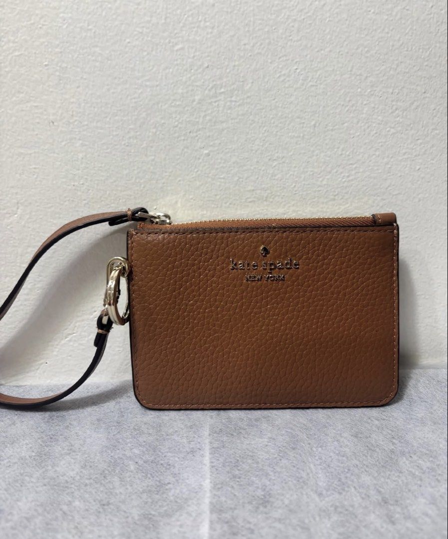 Kate Spade Brown Leather Cardholder Wristlet (Category: Wallets & Card holders) located in Mandaluyong City. Submitted by isydln (Listing ID 1440824973, Image 1). Description: -This is new without tag - Brand: Kate Spade - Material: Brown pebbled leather - Closure: Zip closure - Features: Wrist strap, multiple card slots on the back - Size: Small and compact - Ideal for: Everyday essentials, travel.