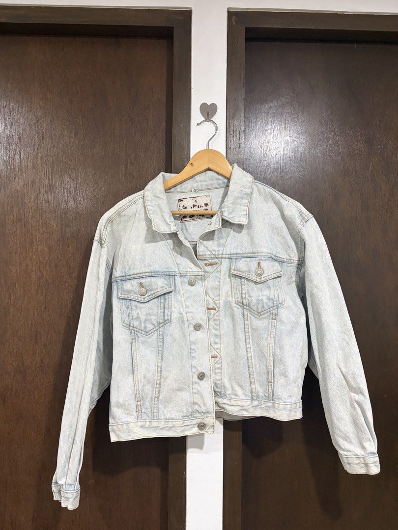 Light Wash Denim Jacket with Back Buckle Detail (Category: Coats, Jackets and Outerwear) located in Makati City. Submitted by jjnsn (Listing ID 1440892831, Image 1). Description: Decluttering!! Classic light wash denim jacket with button-up closure and two chest pockets. Features adjustable back straps for a custom fit. Oversized for XS-S. Just the right fit for Medium. .