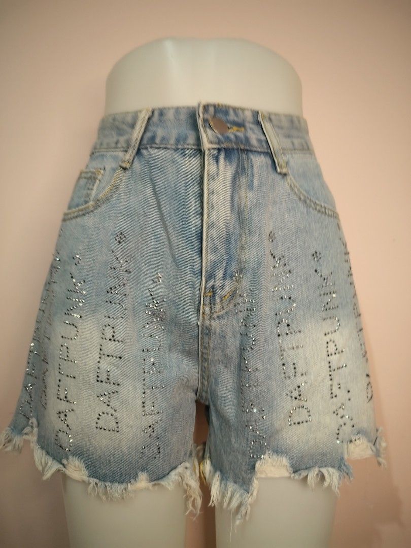 Light Wash Denim Shorts with Rhinestone Text (Category: Shorts) located in Manila. Submitted by lasugasjes06660 (Listing ID 1440922642, Image 1). Description: - Light wash denim shorts - Frayed hem - Rhinestone detail spelling 'DAFT PUNK' - High-waisted style - Ideal for night outs or festival wear - Unique and eye-catching design.