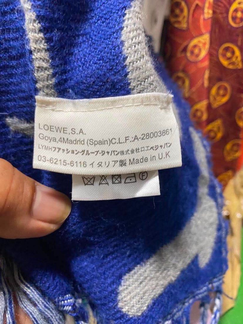LOEWE Scarf Blue Grey Anagram Logo (Category: Luxury Accessories) located in Baguio. Submitted by cleverlion_e92944 (Listing ID 1440871729, Image 3). Description: - Authentic LOEWE scarf - Iconic Anagram logo in blue and grey - Fringed edges - Made in UK - Approx. [insert length] x [insert width] inches - Perfect for adding a pop of color and luxury - Please check photos for detailed condition.