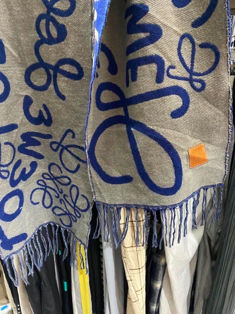 LOEWE Scarf Blue Grey Anagram Logo (Category: Luxury Accessories) located in Baguio. Submitted by cleverlion_e92944 (Listing ID 1440871729, Image 2). Description: - Authentic LOEWE scarf - Iconic Anagram logo in blue and grey - Fringed edges - Made in UK - Approx. [insert length] x [insert width] inches - Perfect for adding a pop of color and luxury - Please check photos for detailed condition.