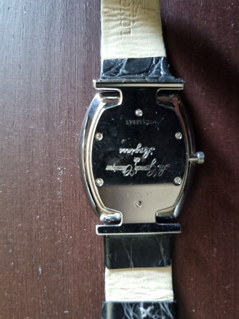 Longines La Grande Classique Quartz Watch (Category: Luxury Watches) located in Makati City. Submitted by amveee (Listing ID 1440787952, Image 3). Description: - Brand: Longines - Model: La Grande Classique - Strap: Black leather with crocodile texture - Dial: White with Roman numerals - Caseback: Displays model name and serial numbers - Style: Classic, elegant timepiece.
