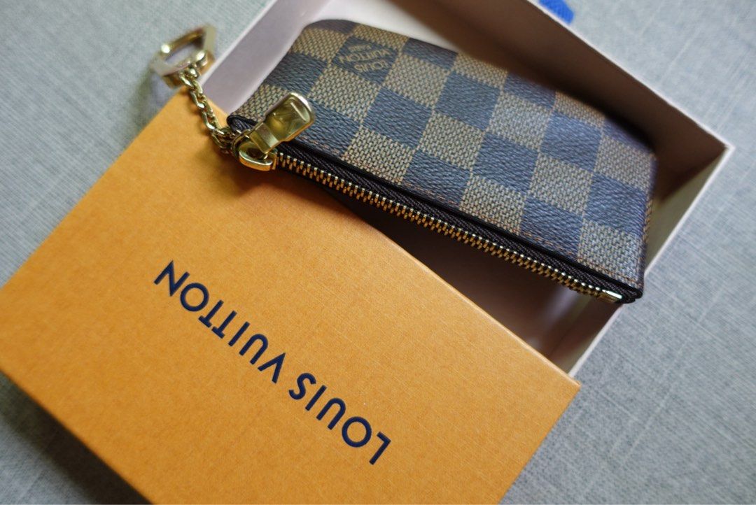 Louis Vuitton Damier Ebene Canvas Coin Pouch (Category: Luxury Bags & Wallets) located in Santa Rosa. Submitted by iam.mvc_ (Listing ID 1440832471, Image 3). Description: - Authentic Louis Vuitton Key pouch/cles - Damier Ebene canvas - Includes original box - Gold hardware - Secure zipper closure - Ideal for organizing coins or cards .