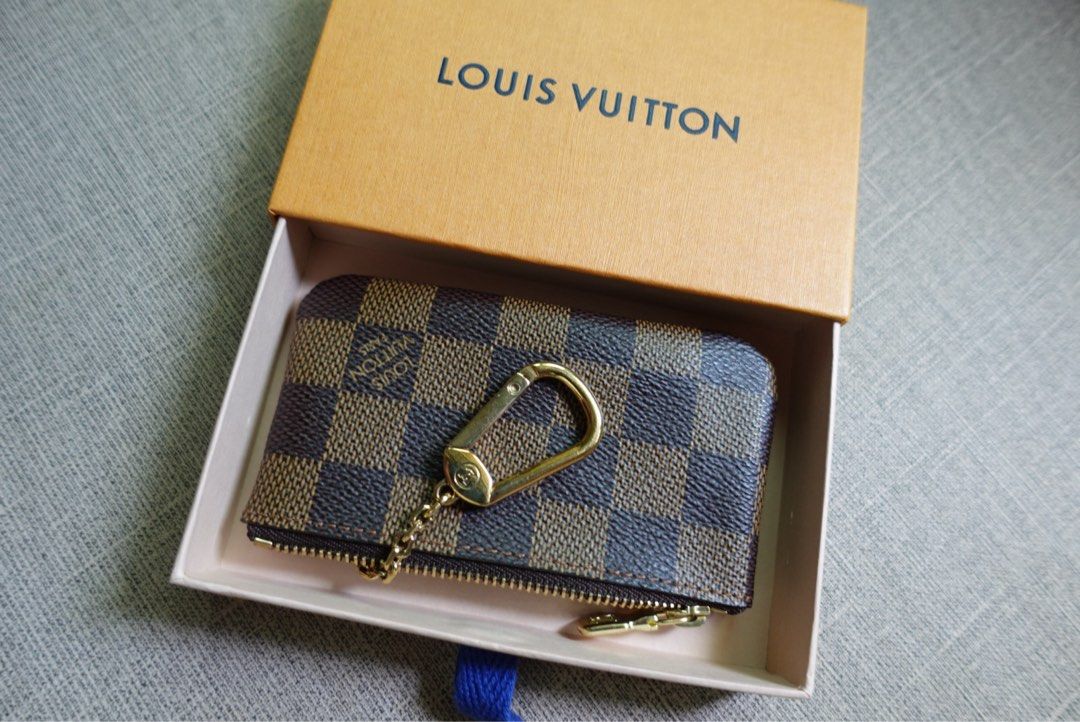 Louis Vuitton Damier Ebene Canvas Coin Pouch (Category: Luxury Bags & Wallets) located in Santa Rosa. Submitted by iam.mvc_ (Listing ID 1440832471, Image 2). Description: - Authentic Louis Vuitton Key pouch/cles - Damier Ebene canvas - Includes original box - Gold hardware - Secure zipper closure - Ideal for organizing coins or cards .
