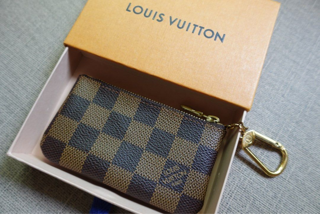 Louis Vuitton Damier Ebene Canvas Coin Pouch (Category: Luxury Bags & Wallets) located in Santa Rosa. Submitted by iam.mvc_ (Listing ID 1440832471, Image 1). Description: - Authentic Louis Vuitton Key pouch/cles - Damier Ebene canvas - Includes original box - Gold hardware - Secure zipper closure - Ideal for organizing coins or cards .