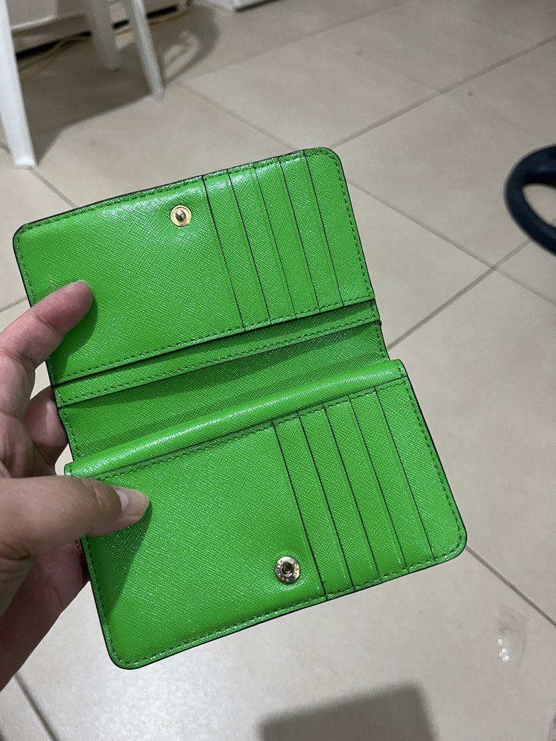 Marc Jacobs Pink Leather Bi-Fold Wallet (Category: Luxury Bags & Wallets) located in Quezon City. Submitted by yumiizashop (Listing ID 1440910561, Image 2). Description: - Pink bi-fold wallet by Marc Jacobs - Vibrant bright green interior - Multiple card slots for organization - Secure zip compartment - Elegant gold hardware detail on the front - Compact design, fits easily in pockets or small bags.