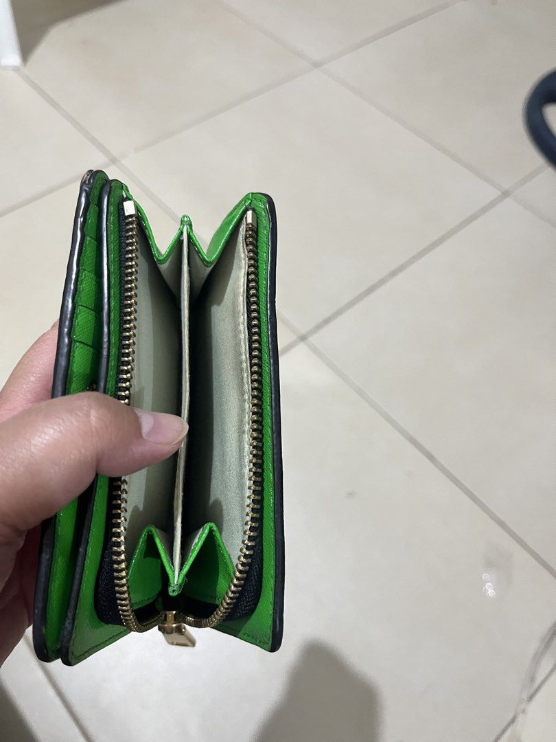 Marc Jacobs Pink Leather Bi-Fold Wallet (Category: Luxury Bags & Wallets) located in Quezon City. Submitted by yumiizashop (Listing ID 1440910561, Image 3). Description: - Pink bi-fold wallet by Marc Jacobs - Vibrant bright green interior - Multiple card slots for organization - Secure zip compartment - Elegant gold hardware detail on the front - Compact design, fits easily in pockets or small bags.