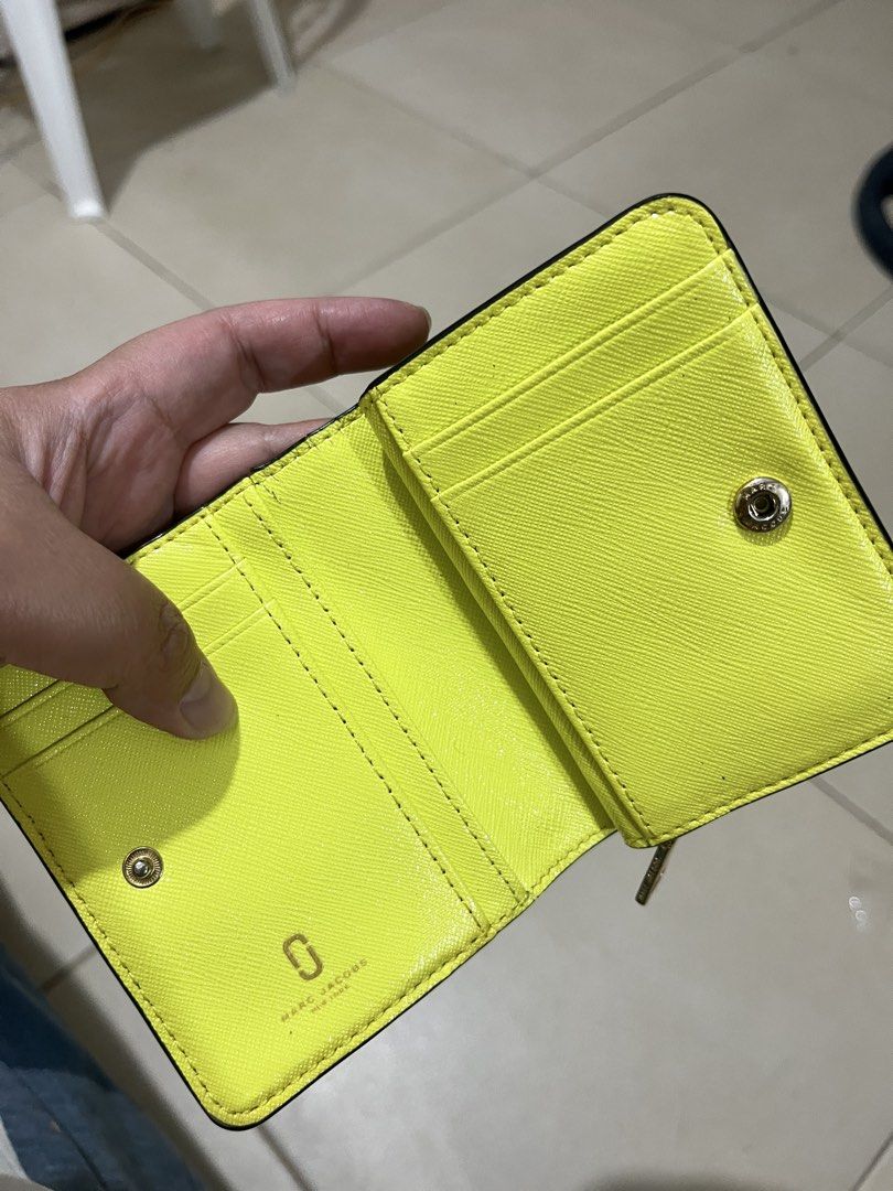Marc Jacobs Snapshot Compact Wallet Blue (Category: Luxury Bags & Wallets) located in Quezon City. Submitted by yumiizashop (Listing ID 1440910413, Image 2). Description: - Brand: Marc Jacobs - Color: Blue exterior, bright yellow interior - Features: Zip compartment, card slots - Hardware: Gold - Size: Small and compact, fits easily in pockets/small bags - Ideal for: Carrying essentials on the go.