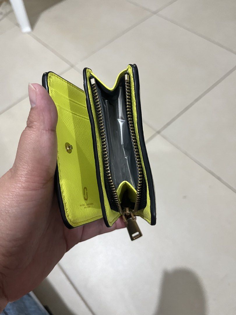 Marc Jacobs Snapshot Compact Wallet Blue (Category: Luxury Bags & Wallets) located in Quezon City. Submitted by yumiizashop (Listing ID 1440910413, Image 3). Description: - Brand: Marc Jacobs - Color: Blue exterior, bright yellow interior - Features: Zip compartment, card slots - Hardware: Gold - Size: Small and compact, fits easily in pockets/small bags - Ideal for: Carrying essentials on the go.