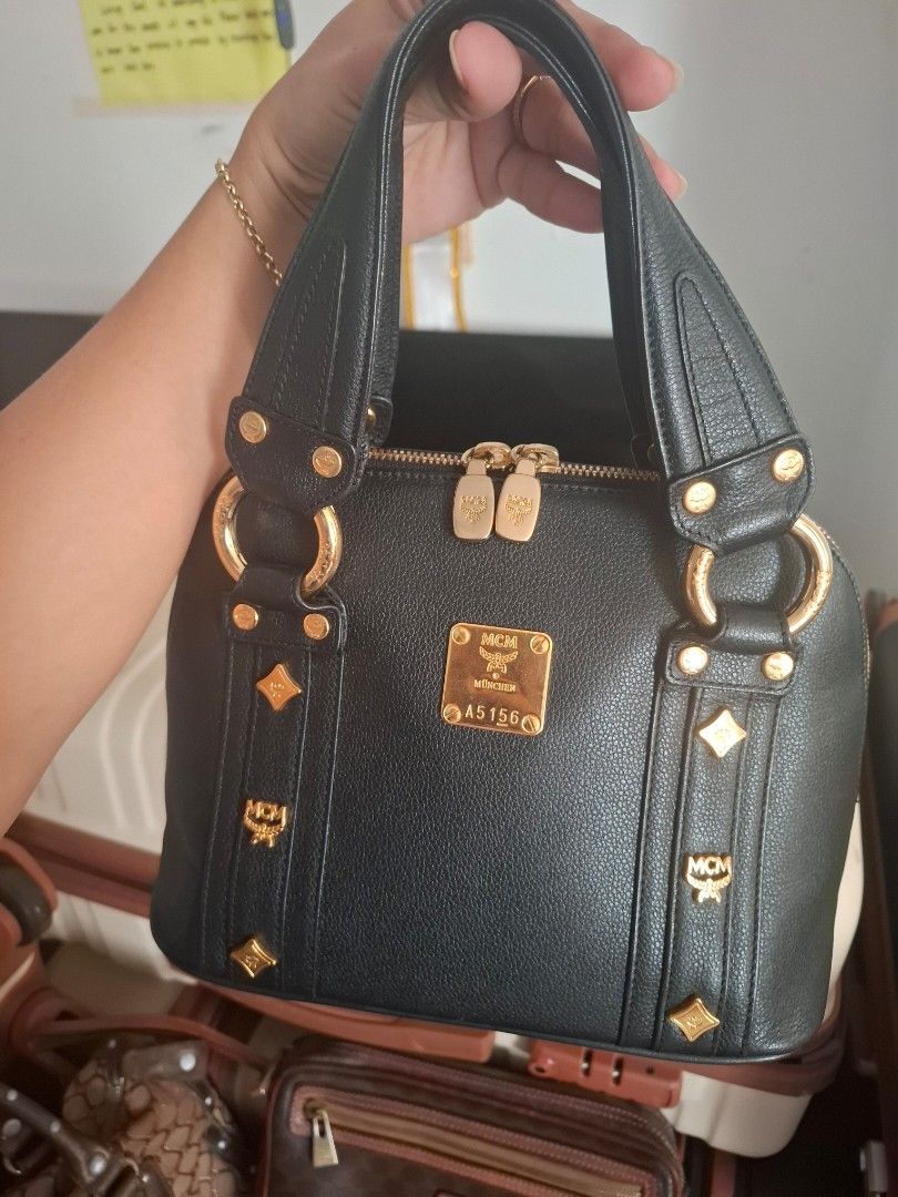 MCM Black Leather Gold Hardware Shoulder Bag (Category: Luxury Bags & Wallets) located in Muntinlupa City. Submitted by gentlelion-abbb (Listing ID 1440759446, Image 2). Description: - Authentic black MCM shoulder bag - Elegant gold hardware details - Iconic MCM logo plate - Secure zipper closure - Beautifully textured leather - Comfortable and sturdy handles - Ideal for everyday wear.