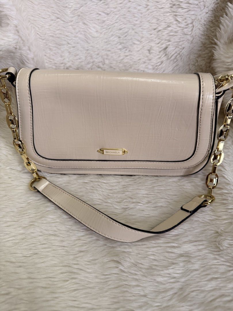 Michaela Cream Shoulder Bag with Gold Chain (Category: Shoulder Bags) located in Mandaluyong City. Submitted by classymissy014 (Listing ID 1440856143, Image 2). Description: - Chic cream-colored shoulder bag - Elegant textured finish - Versatile with gold chain strap and leather strap options - Secure magnetic snap closure on flap - Organized interior with zippered compartment and slip pocket - Spotless interior lining - Ideal for everyday wear a