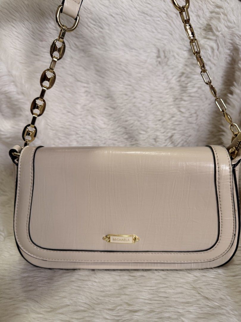 Michaela Cream Shoulder Bag with Gold Chain (Category: Shoulder Bags) located in Mandaluyong City. Submitted by classymissy014 (Listing ID 1440856143, Image 1). Description: - Chic cream-colored shoulder bag - Elegant textured finish - Versatile with gold chain strap and leather strap options - Secure magnetic snap closure on flap - Organized interior with zippered compartment and slip pocket - Spotless interior lining - Ideal for everyday wear a