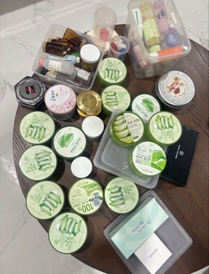 Empty containers (Category: Face Care) located in Singapore. Submitted by jodiestrawberry (Listing ID 1440873722, Image 1). Description: - Bundle includes Nature Republic Aloe Vera 92% Soothing Gels. - Also includes assorted skincare items: Dove products, G-Shock watch tin, John Jacobs box. - Condition varies: some items are full, others are partially used. - Ideal for replenishing your supply of the popular Aloe Vera Soothing Gel. - Great value 