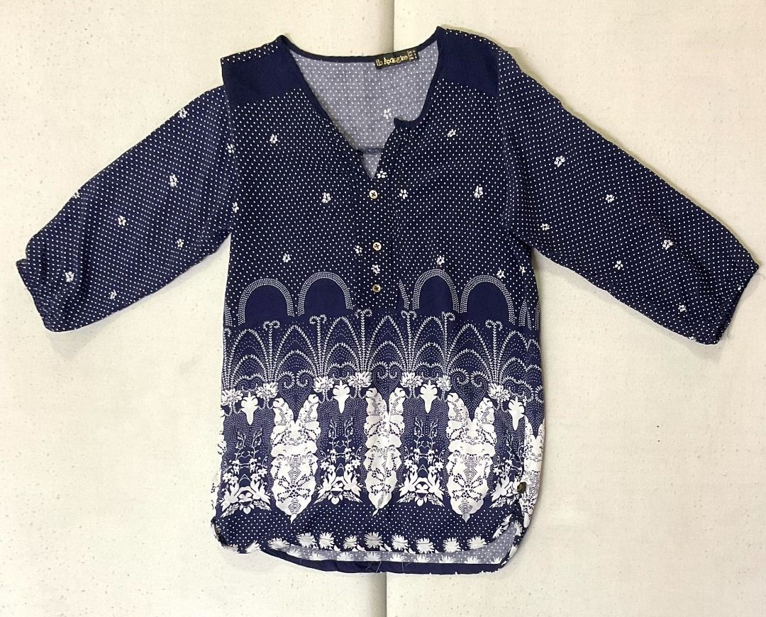 Navy Blue extended Sleeve Blouse with White Polka Dots and Pattern (Category: Blouses) located in Paranaque City. Submitted by decluttering-all (Listing ID 1440779665, Image 3). Description: - Navy blue blouse with classic white polka dots - Flattering V-neck with button details - Comfortable extended sleeves - Unique patterned hem for added style - Versatile for casual outings or dressing up - light cool fabric, perfect for warm weather measurem