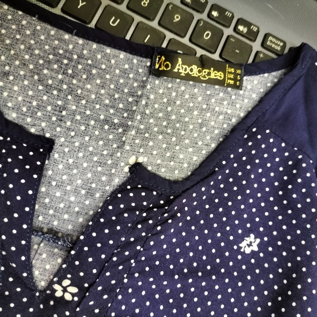 Navy Blue extended Sleeve Blouse with White Polka Dots and Pattern (Category: Blouses) located in Paranaque City. Submitted by decluttering-all (Listing ID 1440779665, Image 2). Description: - Navy blue blouse with classic white polka dots - Flattering V-neck with button details - Comfortable extended sleeves - Unique patterned hem for added style - Versatile for casual outings or dressing up - light cool fabric, perfect for warm weather measurem