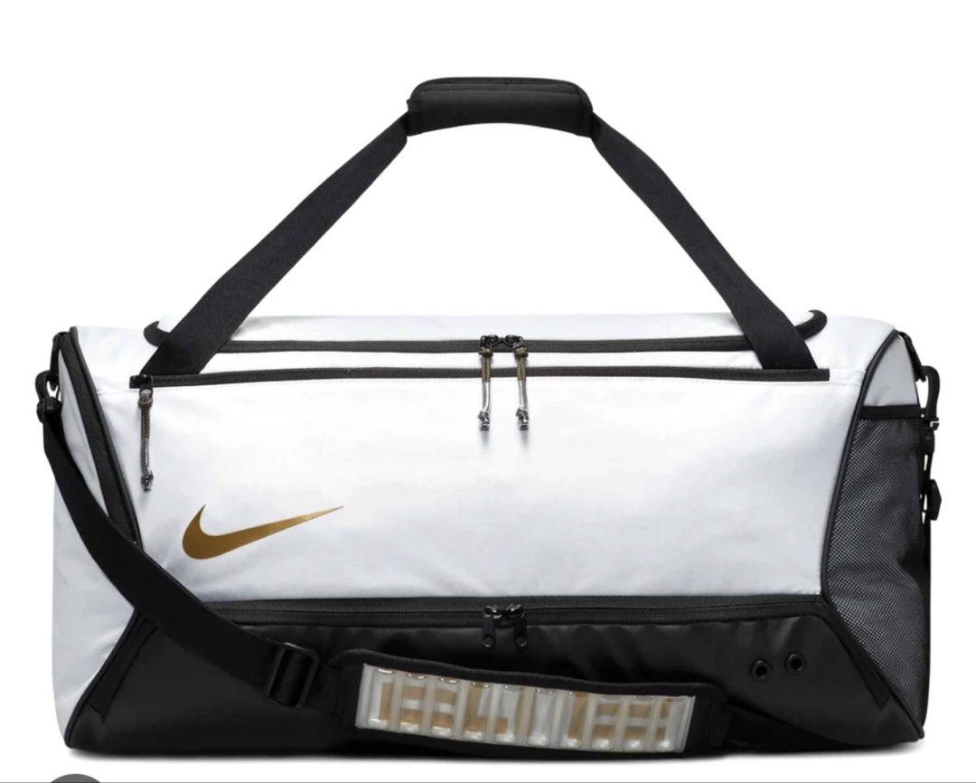 Nike hoops elite training duffle bag 57L (Category: Sling Bags) located in Bulacan. Submitted by elihoh (Listing ID 1440768139, Image 1). Description: - White Nike duffel bag - Black accents and gold Nike swoosh - Main compartment for storage - Convenient side pockets - Adjustable shoulder strap included - Ideal for gym sessions or travel - Spacious interior.