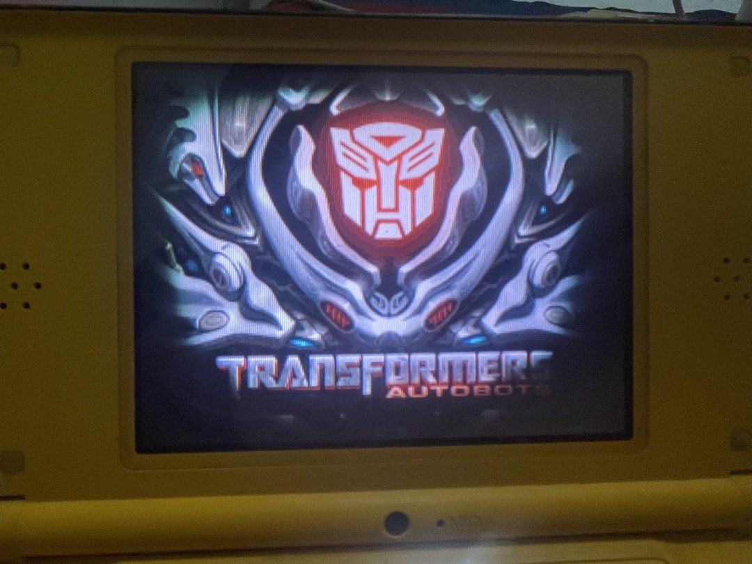 Nintendo DS Lite Yellow with Transformers Autobots Game (Category: Nintendo) located in San Pablo. Submitted by ayeshamiranda1239 (Listing ID 1440886811, Image 1). Description: - Yellow Nintendo DS Lite console - Includes Transformers Autobots game - Console powers on and displays Nintendo DS logo - Screen shows the game's title screen - Ideal for gaming on the go - A classic handheld gaming experience.