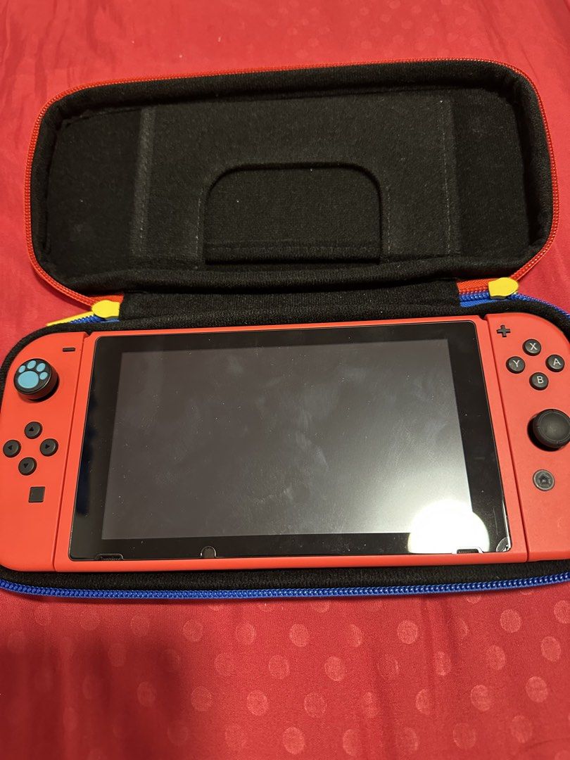 Nintendo Switch Lite (Red) with Mario Case (Category: Nintendo) located in Singapore. Submitted by crystallee1357 (Listing ID 1440866268, Image 1). Description: - Red Nintendo Switch Lite - Includes Mario-themed protective case - Case features soft interior for protection - Ideal for gaming on the go.