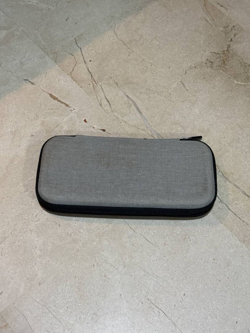 Nintendo Switch/Lite/OLED Case (Category: Nintendo) located in Singapore. Submitted by shyed.4 (Listing ID 1440917790, Image 2). Description: - Official Nintendo Switch protective case - Grey exterior with black interior - Centrepiece folds into a stand for Tabletop Mode - Includes a removable foam insert for a snug fit for Switch Lite models - Durable design for travel and everyday use - 5 switch game catridge slots - Fits the Switch, Switch Lit