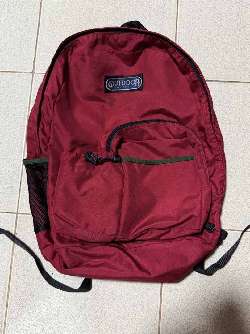 Outdoor Products Red Backpack Made in USA (Category: Backpacks) located in Manila. Submitted by grindnthrift (Listing ID 1440805979, Image 1). Description: - Classic red backpack from Outdoor Products - Made in the USA - Multiple zippered pockets for organization - Drawstring closure on one compartment - Durable material, built to last - Perfect for everyday use or travel adventures.