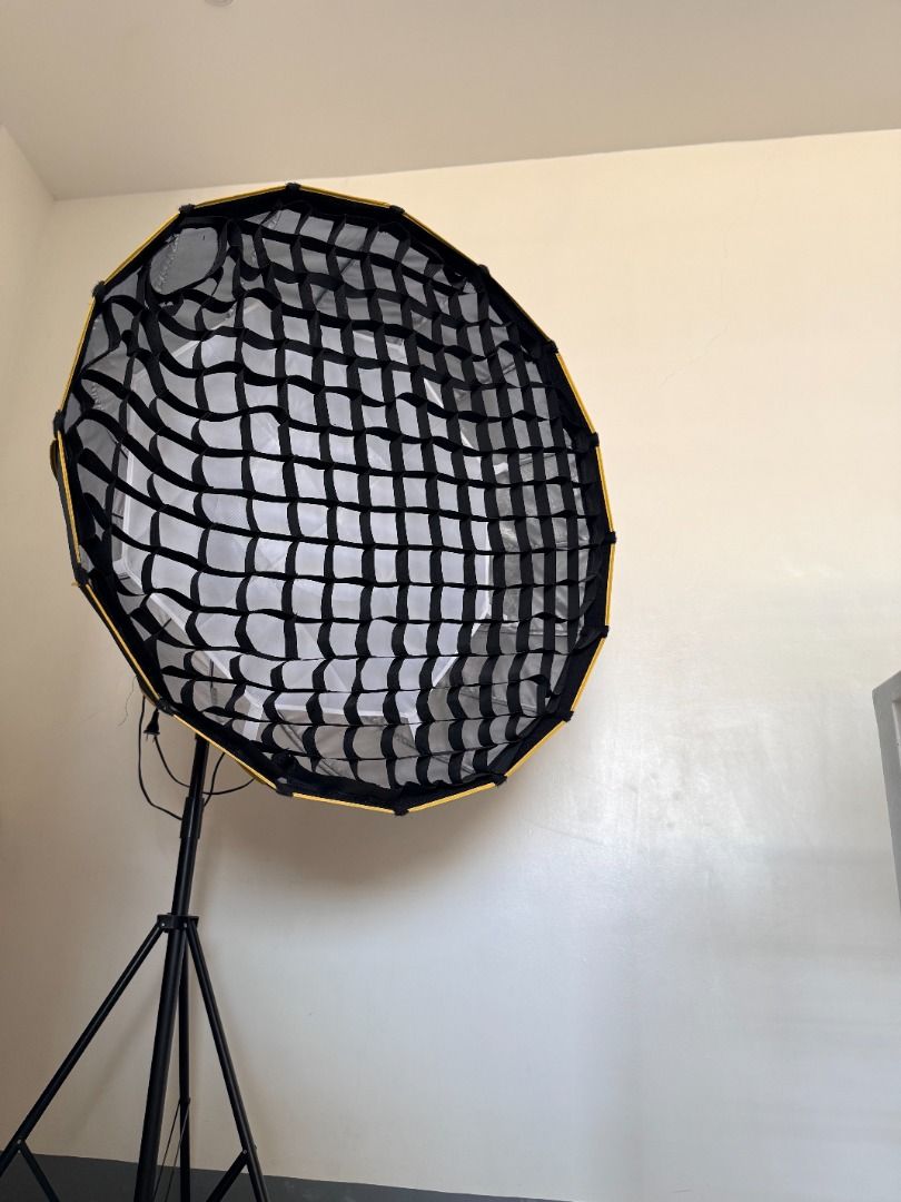 Parabolic Softbox With Grid Bowen Mount Honeycomb 90cm SET (Category: Lighting & Studio Equipment) located in Antipolo. Submitted by jenidee.merchandise (Listing ID 1440778872, Image 1). Description: Parabolic Softbox With Grid Bowen Mount Honeycomb 90cm SET LIKE NEW - seldom used Reason For Selling: Decluttering INCLUDED: 90cm softbox reflector light stand 300w fill light Purchase / Original Price: Php6,000 Selling Price: Php3,500 .