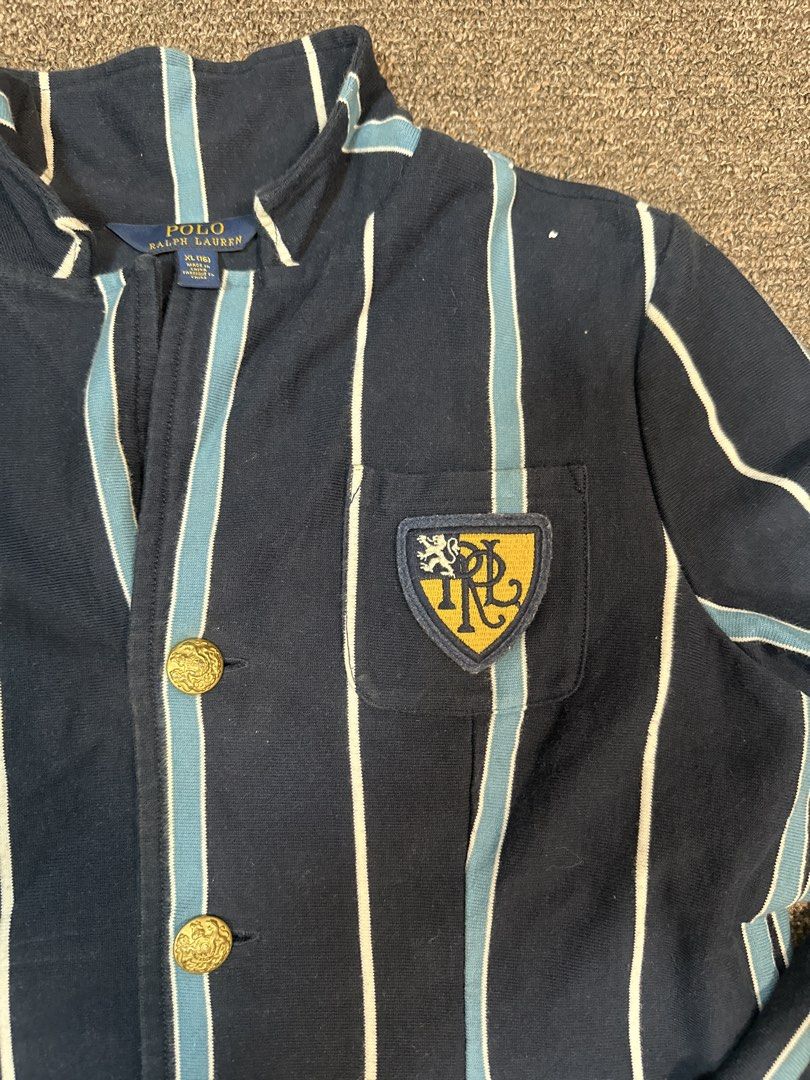 Polo Ralph Lauren Striped Blazer with Crest (Category: Coats, Jackets and Outerwear) located in Mandaluyong City. Submitted by krstls (Listing ID 1440821395, Image 2). Description: - Navy blue Polo Ralph Lauren blazer - White and light blue stripe detailing - Crest embroidered on the left chest - Gold button accents - Ideal for a smart casual outfit.