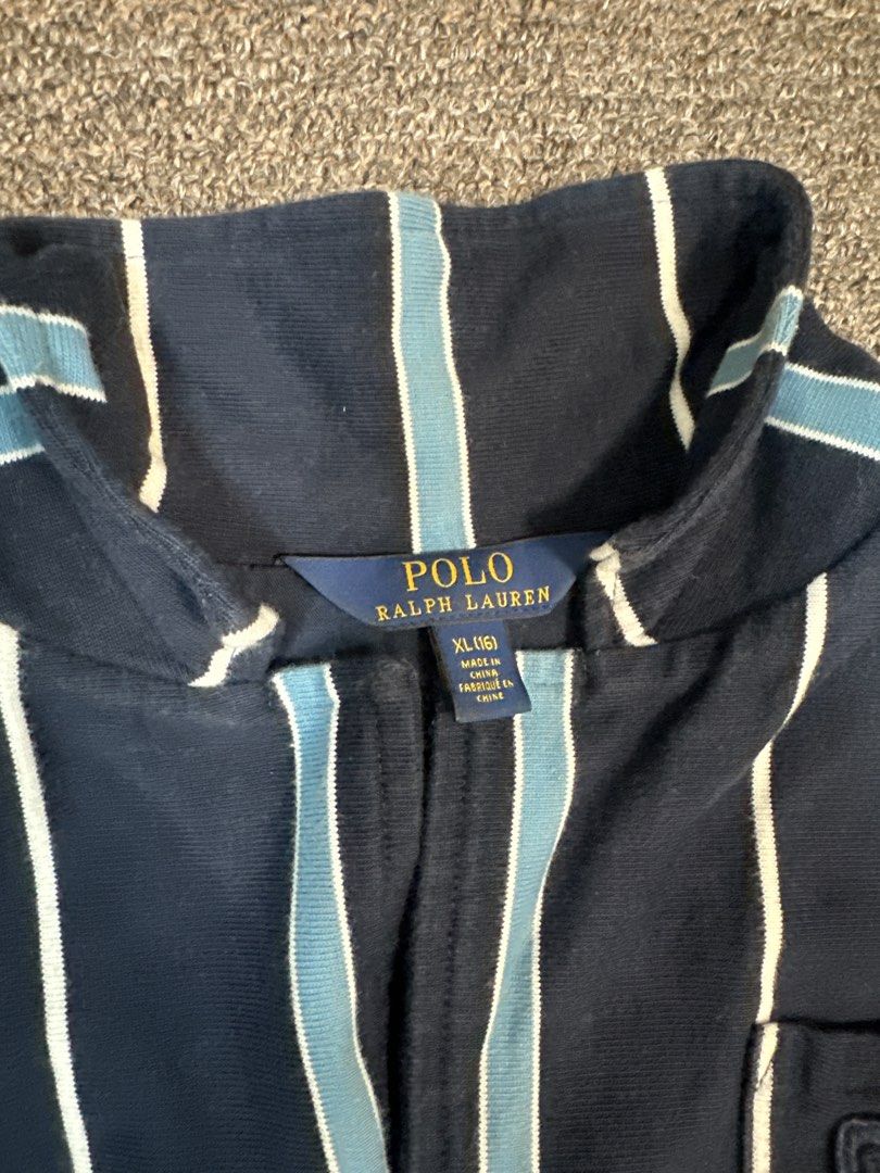 Polo Ralph Lauren Striped Blazer with Crest (Category: Coats, Jackets and Outerwear) located in Mandaluyong City. Submitted by krstls (Listing ID 1440821395, Image 3). Description: - Navy blue Polo Ralph Lauren blazer - White and light blue stripe detailing - Crest embroidered on the left chest - Gold button accents - Ideal for a smart casual outfit.