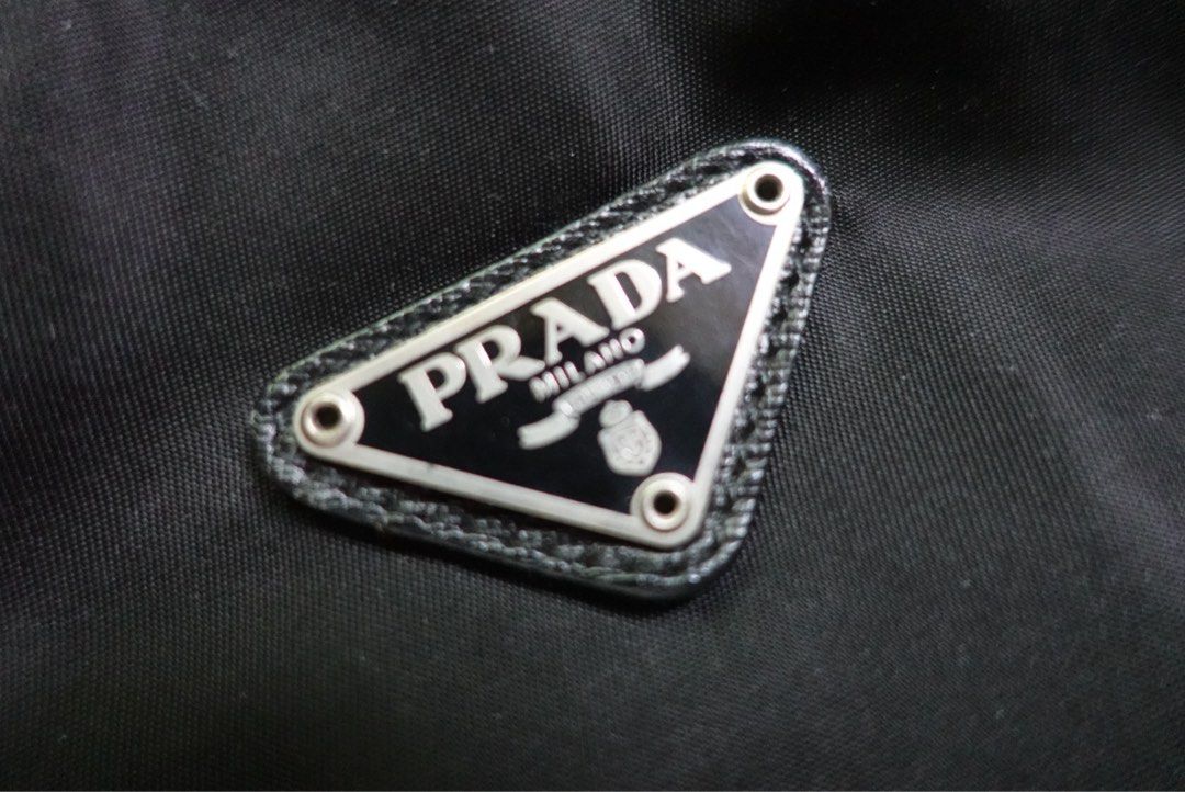 Prada Black Nylon Pouch Bag (Category: Luxury Bags & Wallets) located in Santa Rosa. Submitted by iam.mvc_ (Listing ID 1440835452, Image 3). Description: - Authentic Prada pouch - Black nylon with leather trim - Iconic Prada triangle logo on front - Interior 'Prada Made in Italy' tag - Zipper closure - Ideal for organizing essentials or travel.